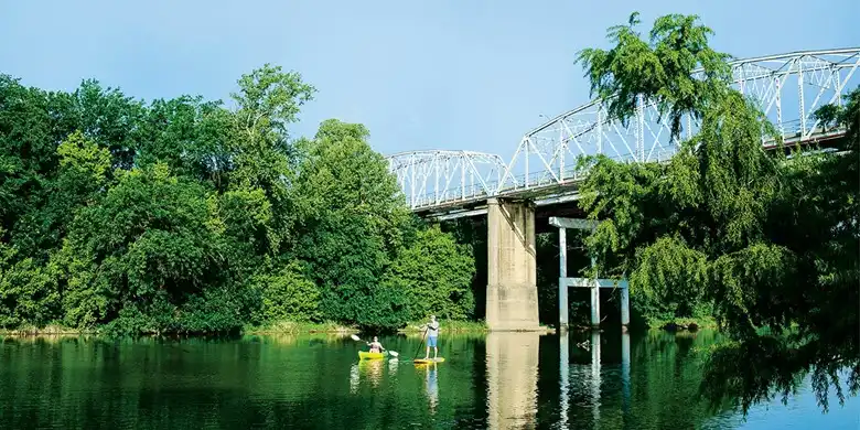 Peaceful lake and bridge in Bastrop, TX – home to Karma Kleaners, your trusted local cleaning company.